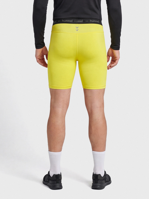 HUMMEL FIRST PERFORMANCE TIGHT SHORTS, BLAZING YELLOW, model